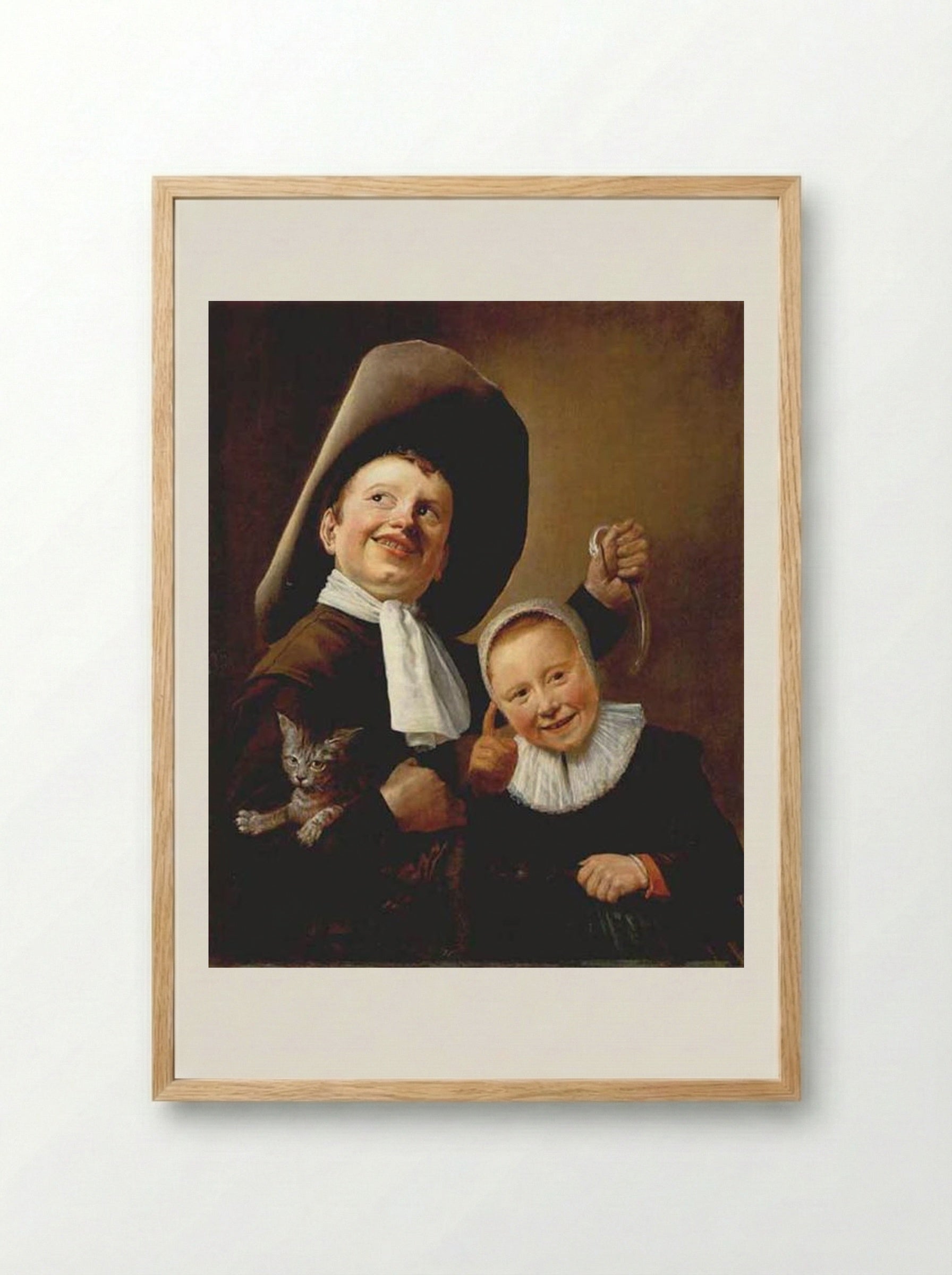A Boy and a Girl with a Cat and an Eel - Judith Leyster - Framed Print Wood