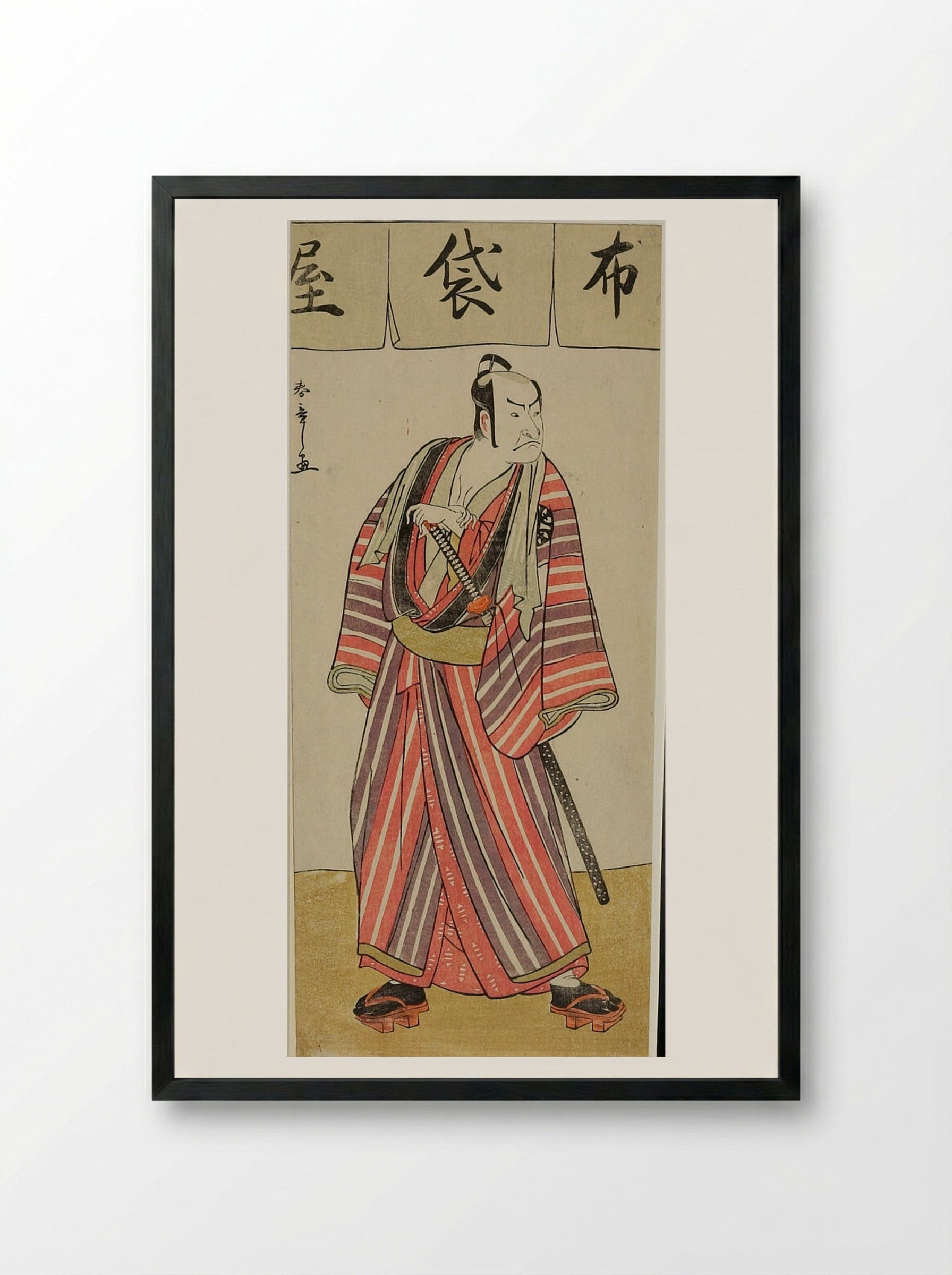 Actor Nakamura Denkūrō II in a Striped Robe - Katsukawa Shunshō - Framed Print Black