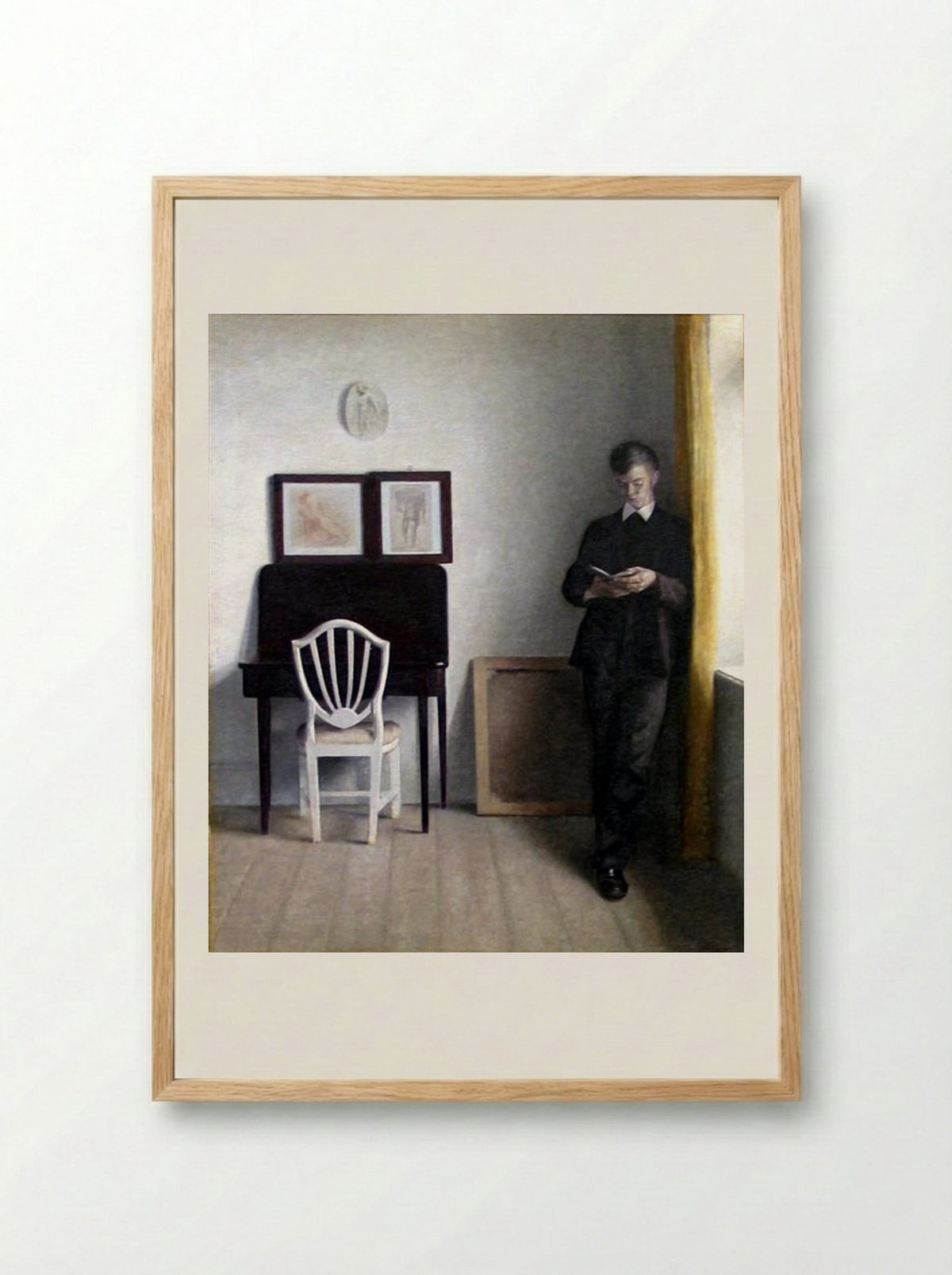 Interior with Young Man Reading - Vilhelm Hammershoi - Framed Print Wood