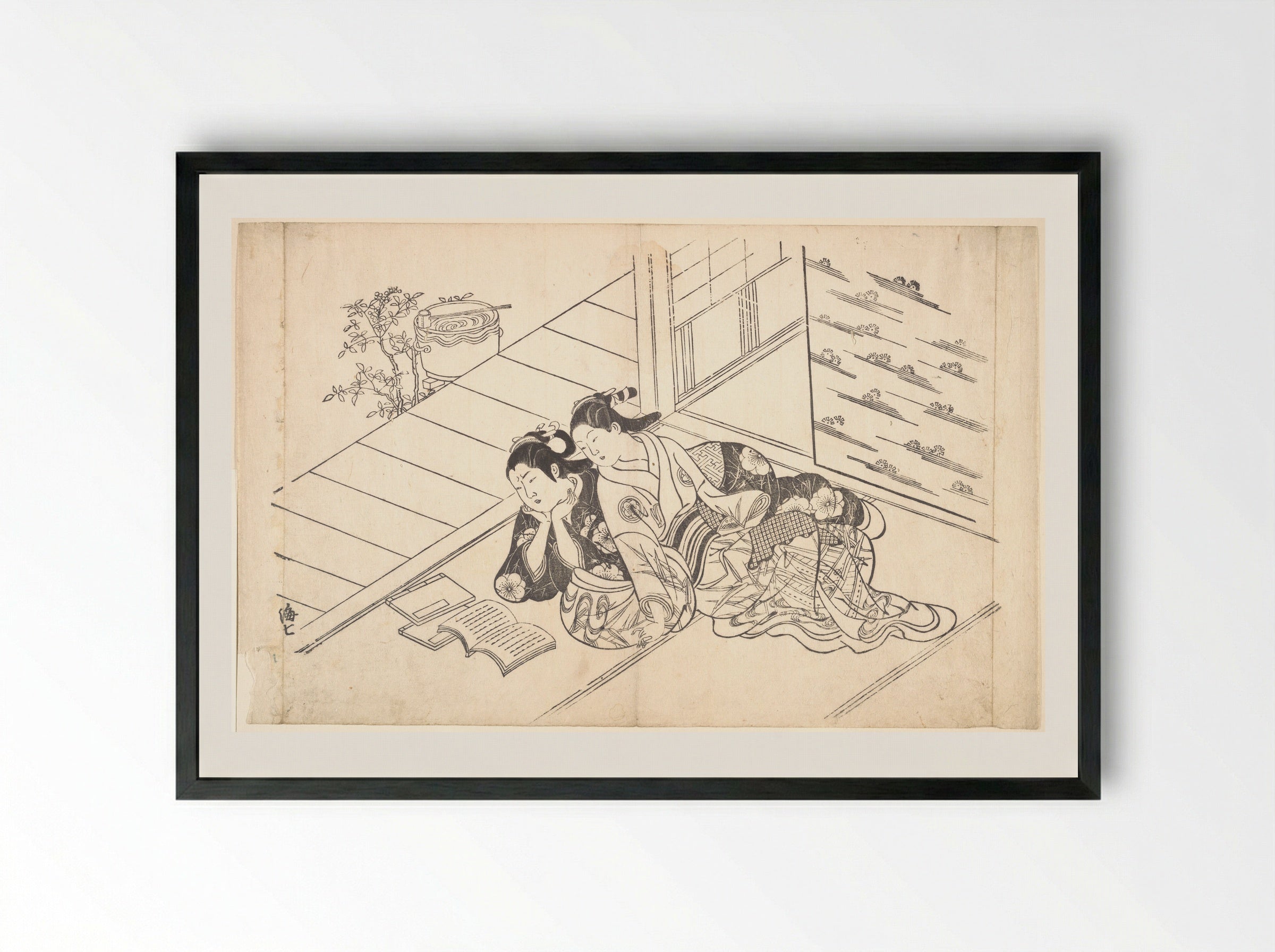 Two Women Reclining on the Floor of a Room and Reading a Book - Nishikawa Sukenobu - Framed Print Black