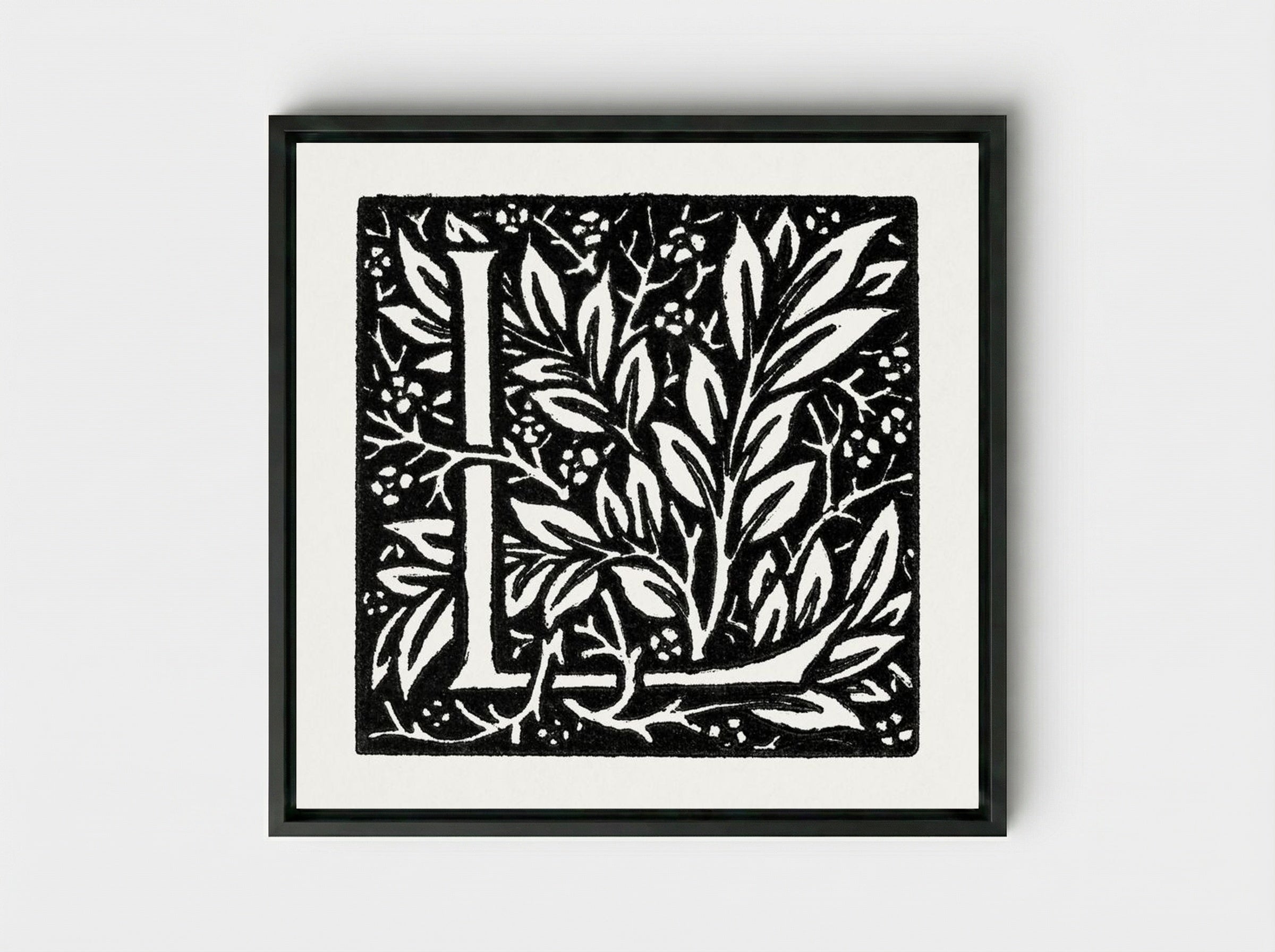 Love is Enough: Initial Letter 'L' entwined with Laurel Leaves - William Morris - Framed Canvas Black